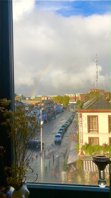 View from a window showing a rainbow.