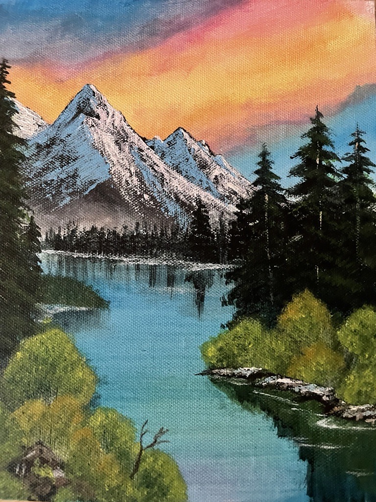 Canvas painting depicting a mountain next to a lake with trees under a sunset sky.